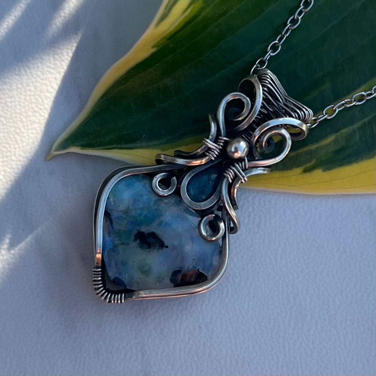 Rainbow Moonstone with Black Tourmaline, Blue Apatite in Antiqued Argentium Silver.